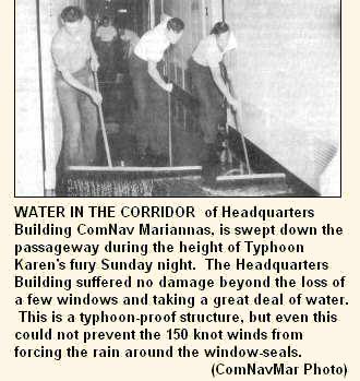 WATER IN THE CORRIDOR of Headquarters Building ComNav Mariannas, is swept down the passageway during the height of Typhoon Karen's fury Sunday night.