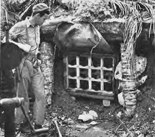  Marine holds up canva cover of ammunition rack built into side of